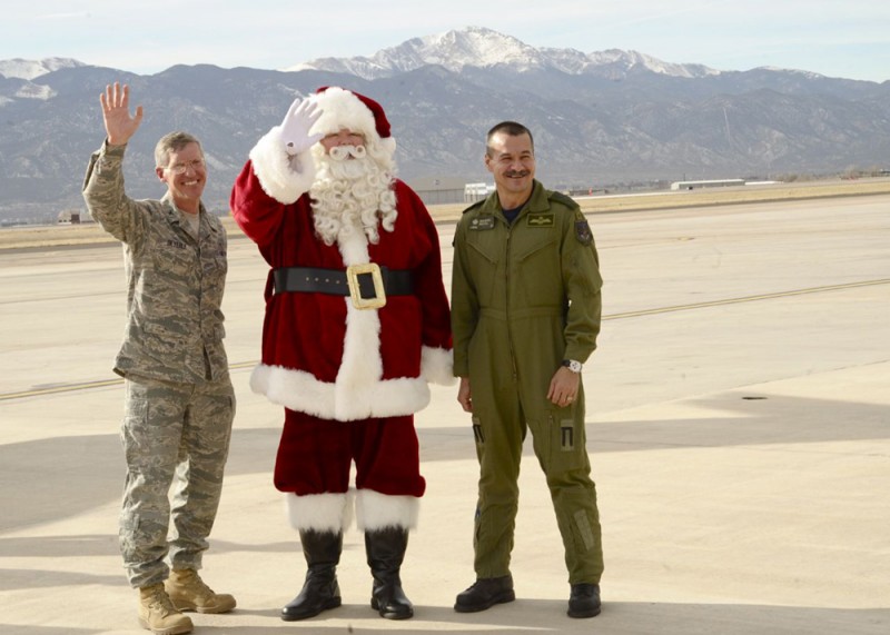 Santa Claus (center) with Col. Marcus Beyerle (left), 21st Dental Squadron commander, and Lt. Gen. J.M. Duval (right), Canadian Forces, Deputy Commander, North American Aerospace Defense Command, at Peterson Air Force Base in Colorado Springs, Colo., during his NORAD mission brief on Dec. 16, 2012.