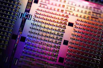 Close-up of a silicon Avalanche Photodetector chip. In the center is a grid of many individual photodectors with different designs, allowing researchers to test various properties of the devices.
