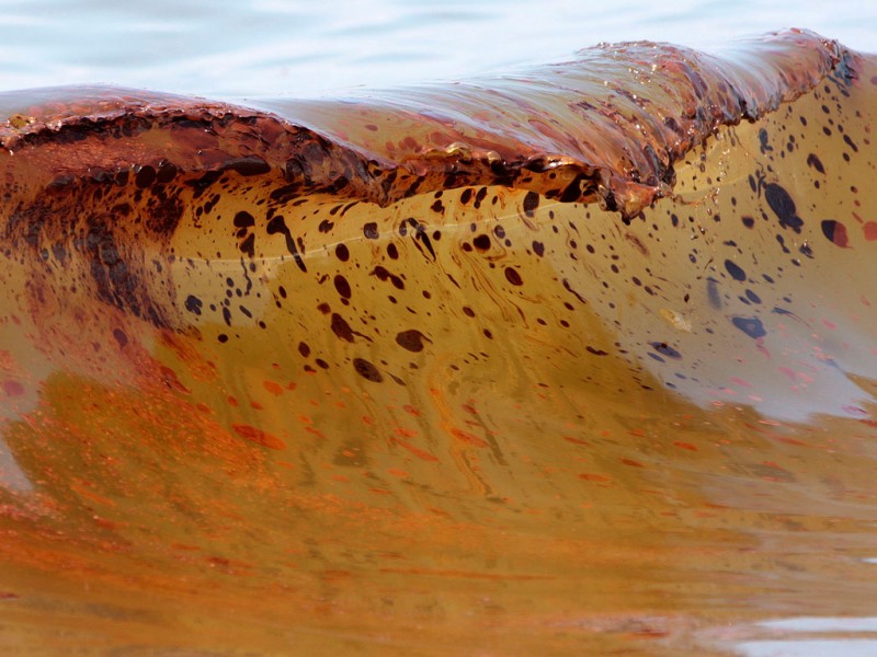 Delicate patterns in the sea breaking on Orange Beach, Alabama, more than 90 miles from the BP oil spill, cannot distract from the mess four to six inches deep on parts of the shore