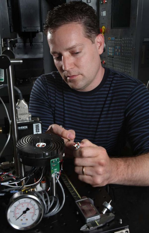 Sandia’s Jeff Koplow makes an adjustment to an earlier prototype of his Air Bearing Heat Exchanger invention. The technology, as known as the “Sandia Cooler,” will significantly reduce the energy needed to cool the processor chips in data centers and large-scale computing environments. (Photo by Dino Vournas) Click on the thumbnail for a high-resolution image.